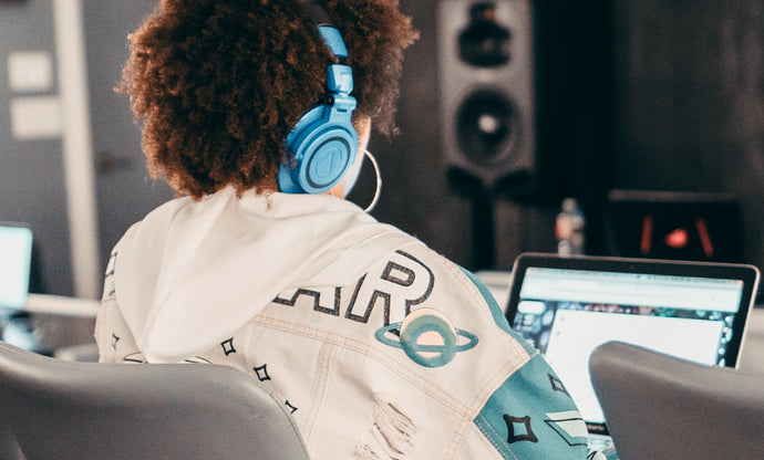 girl wearing headphones on a computer
