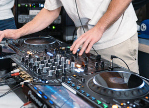 DJ using a turntable and adjusting levels
