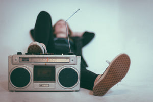 Woman with feet up on a radio.