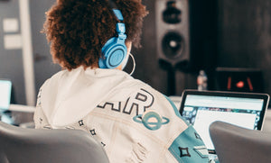 girl wearing headphones on a computer